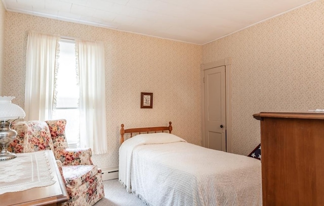 bedroom featuring wallpapered walls and a baseboard radiator