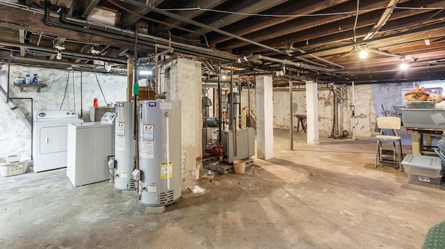 unfinished below grade area with washer and clothes dryer and gas water heater