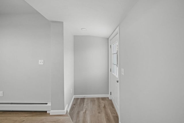 hall featuring light hardwood / wood-style floors and a baseboard heating unit