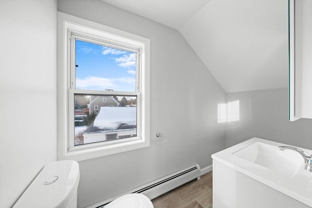 bathroom with lofted ceiling, hardwood / wood-style floors, and toilet