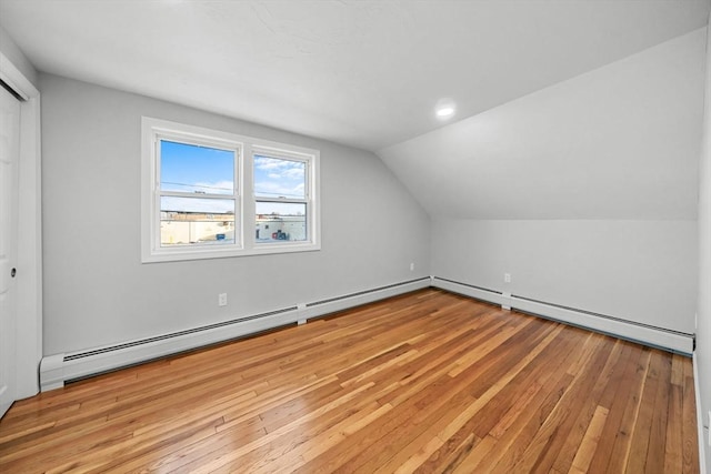 bonus room featuring a baseboard radiator, vaulted ceiling, and light hardwood / wood-style flooring