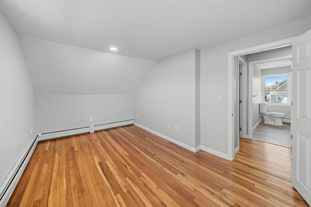 bonus room with baseboard heating, vaulted ceiling, and light wood-type flooring