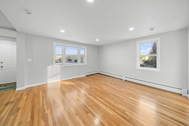 interior space with light hardwood / wood-style floors and baseboard heating