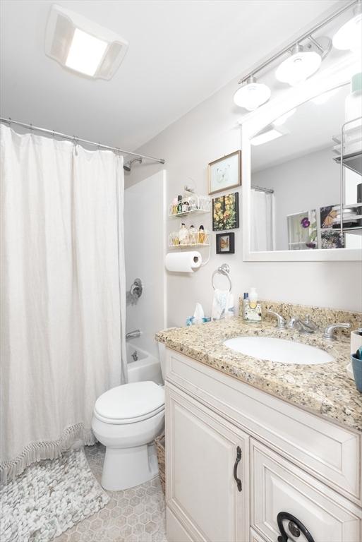 74 E Main St Unit 3, Gloucester, MA 01930 - bathroom featuring vanity, toilet, tile patterned flooring, and shower / bath combination with curtain