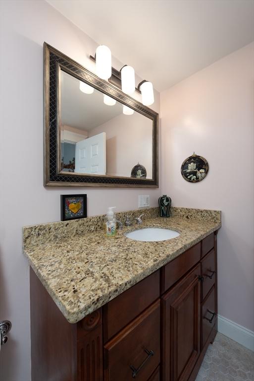 74 E Main St Unit 3, Gloucester, MA 01930 - bathroom featuring vanity, baseboards, and tile patterned floors