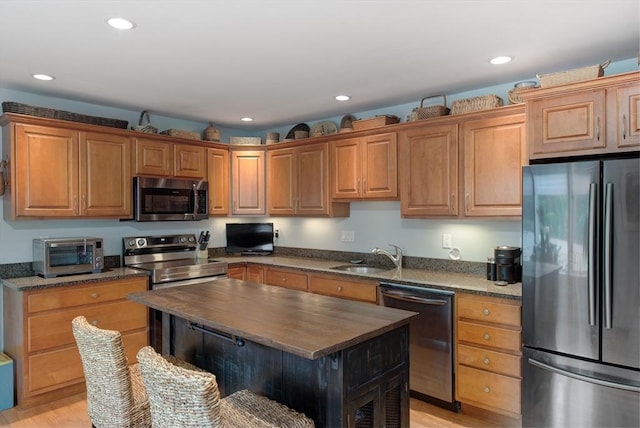 74 E Main St Unit 3, Gloucester, MA 01930 - kitchen with appliances with stainless steel finishes, wooden counters, a sink, recessed lighting, and light wood-style floors