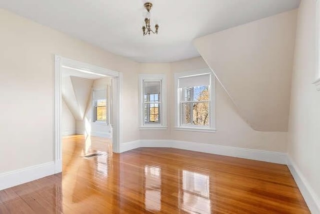 4-6 W St, Arlington, MA 02476 - bonus room with wood finished floors, baseboards, and a chandelier