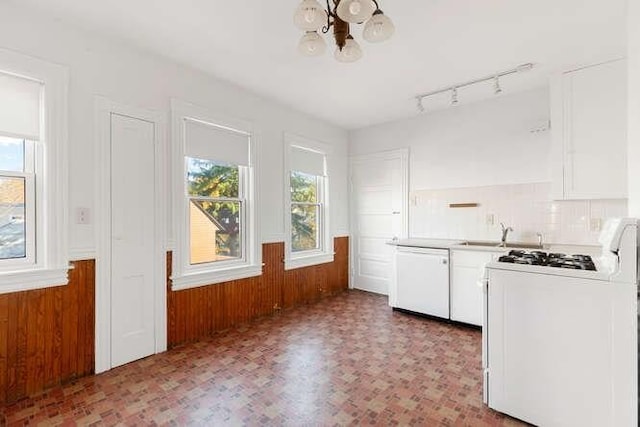 4-6 W St, Arlington, MA 02476 - kitchen with white appliances, a chandelier, white cabinetry, wood walls, and a sink