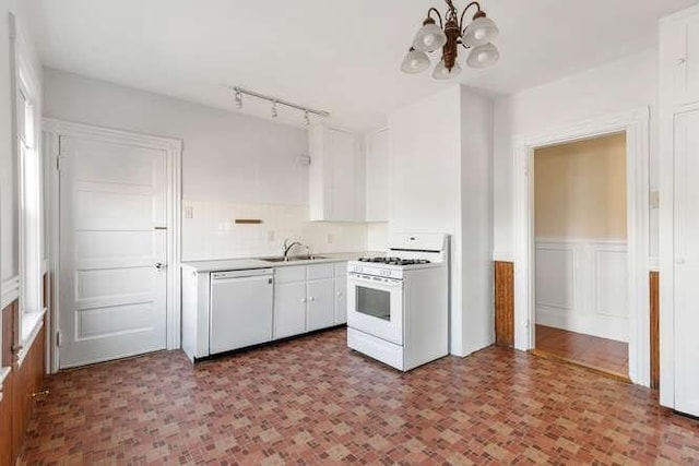 4-6 W St, Arlington, MA 02476 - kitchen featuring white appliances, a chandelier, white cabinetry, light countertops, and a sink