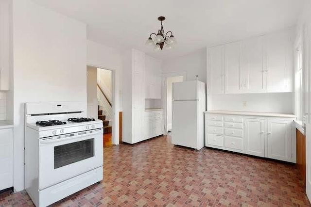 4-6 W St, Arlington, MA 02476 - kitchen featuring white appliances, a chandelier, white cabinetry, decorative light fixtures, and light countertops