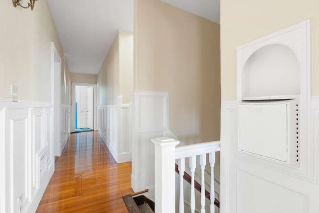 4-6 W St, Arlington, MA 02476 - corridor with an upstairs landing, a decorative wall, wainscoting, and light wood finished floors