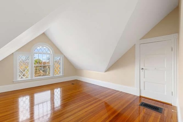 4-6 W St, Arlington, MA 02476 - additional living space with lofted ceiling, wood finished floors, and baseboards