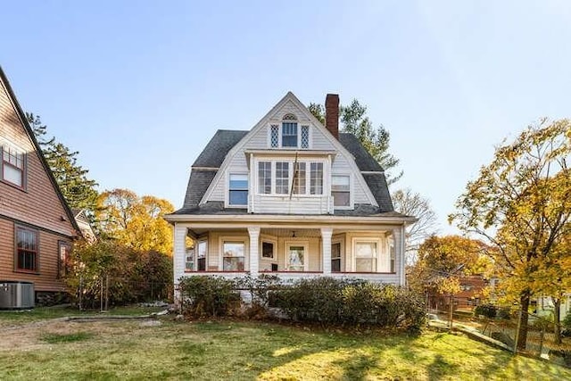 4-6 W St, Arlington, MA 02476 - shingle-style home featuring a gambrel roof, a chimney, central air condition unit, and a front yard