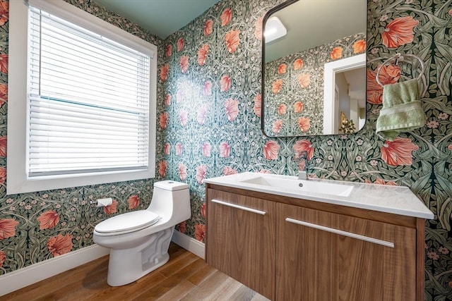 16 Walker St Unit 16, Medford, MA 02155 - bathroom with wallpapered walls, wood finished floors, baseboards, vanity, and toilet