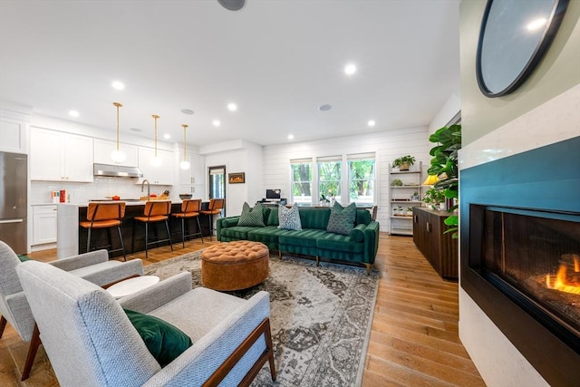 16 Walker St Unit 16, Medford, MA 02155 - living area with a lit fireplace, light wood finished floors, and recessed lighting