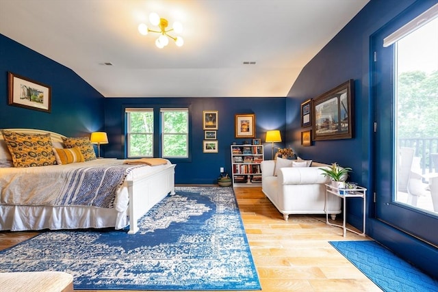 16 Walker St Unit 16, Medford, MA 02155 - bedroom with vaulted ceiling, wood finished floors, and access to exterior