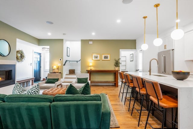 16 Walker St Unit 16, Medford, MA 02155 - living area featuring light wood finished floors, a glass covered fireplace, and recessed lighting