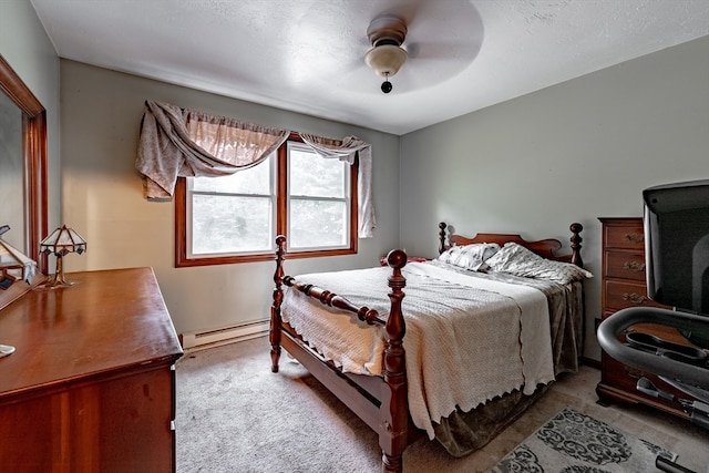 carpeted bedroom with baseboard heating and ceiling fan