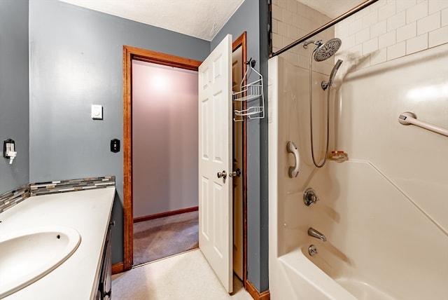 bathroom with washtub / shower combination, a textured ceiling, and vanity