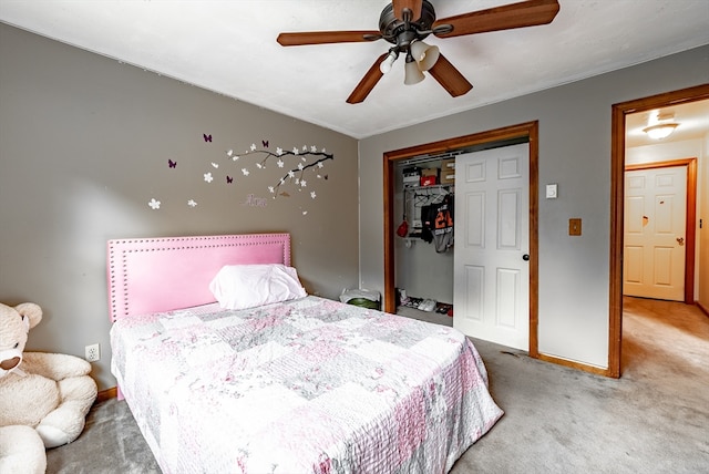 carpeted bedroom featuring ceiling fan and a closet