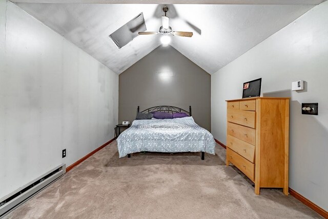 bedroom featuring a baseboard heating unit, carpet, vaulted ceiling, and ceiling fan