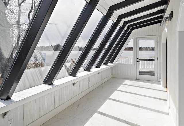 unfurnished sunroom with french doors and a water view