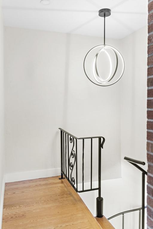 stairway with baseboards and wood finished floors