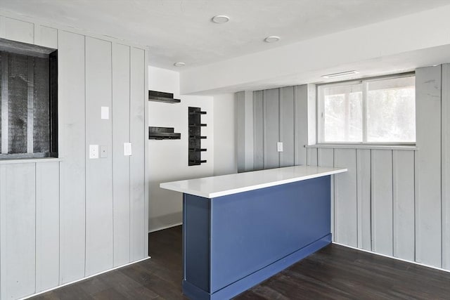 kitchen featuring light countertops, white cabinets, dark wood-style flooring, and a peninsula