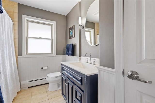 bathroom with toilet, a wainscoted wall, tile patterned flooring, baseboard heating, and vanity