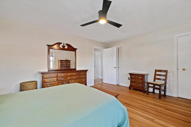 bedroom with a ceiling fan, baseboards, and wood finished floors