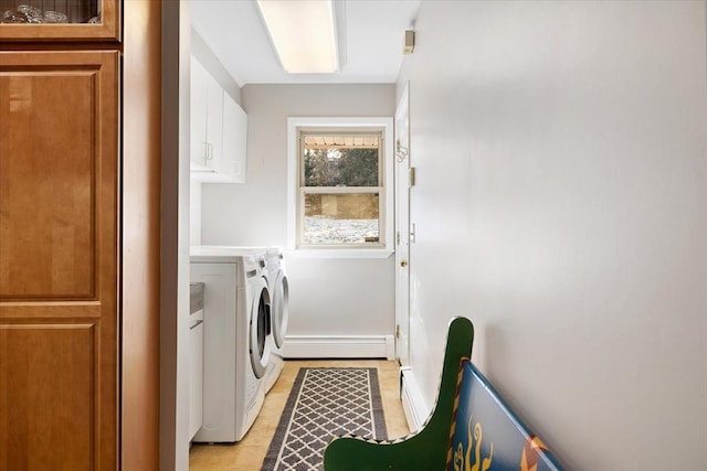 washroom with cabinet space, washing machine and dryer, a baseboard heating unit, and baseboards