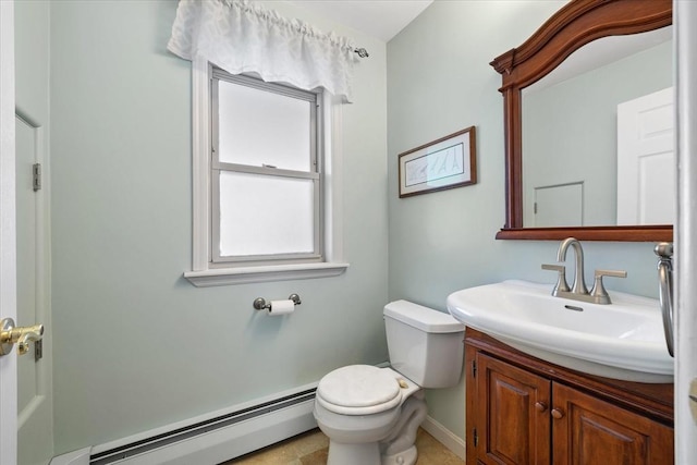 bathroom with a baseboard radiator, baseboards, vanity, and toilet