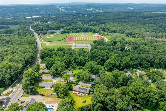 birds eye view of property with a wooded view