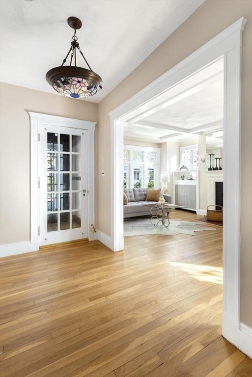 doorway with light wood-style floors and baseboards