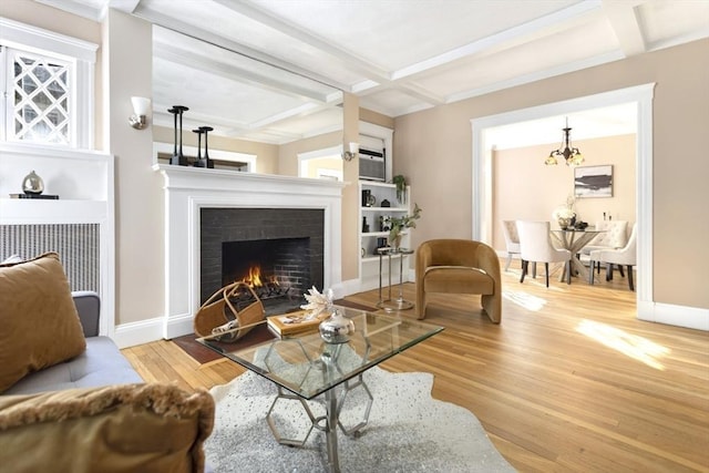living room with a fireplace with flush hearth, wood finished floors, coffered ceiling, beamed ceiling, and baseboards