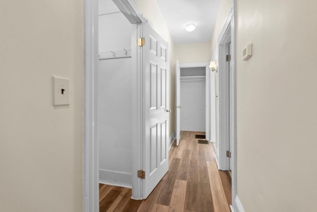 hall with hardwood / wood-style floors