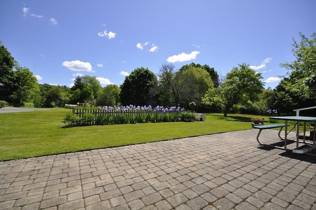 706 Washington St, East Bridgewater, MA 02333 - view of community featuring a lawn, a patio area, and view of wooded area