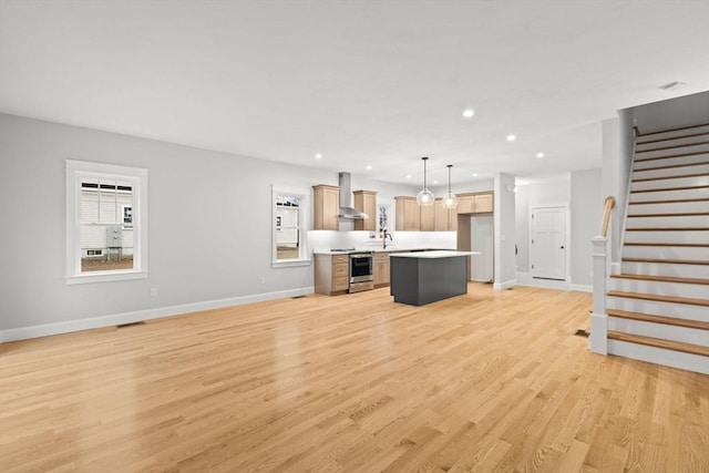 27 Leonard St Unit 27, Bridgewater, MA 02324 - unfurnished living room with recessed lighting, light wood-type flooring, and stairs