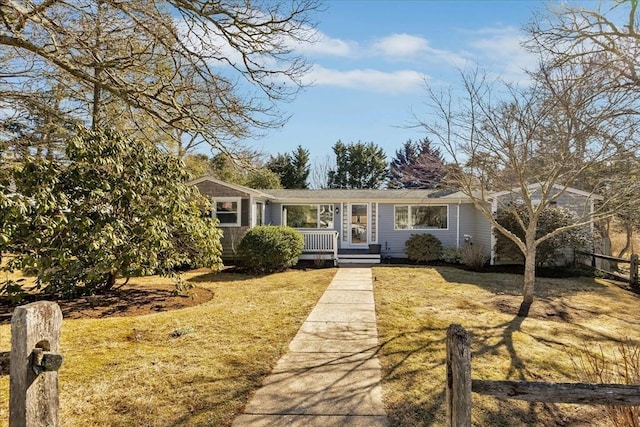 view of front of house with a front yard and fence