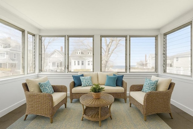 sunroom / solarium with baseboards and a wealth of natural light