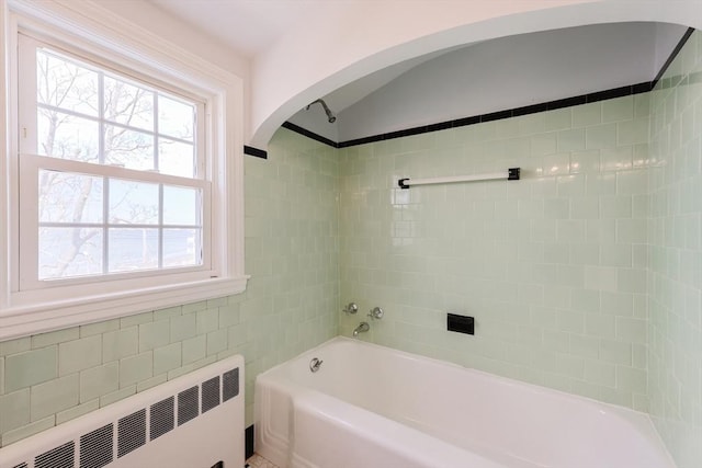 bathroom with radiator heating unit and shower / bathing tub combination
