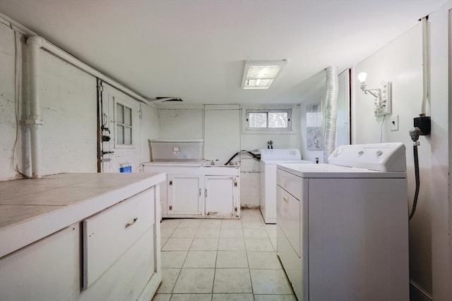 clothes washing area with cabinet space and washer and dryer