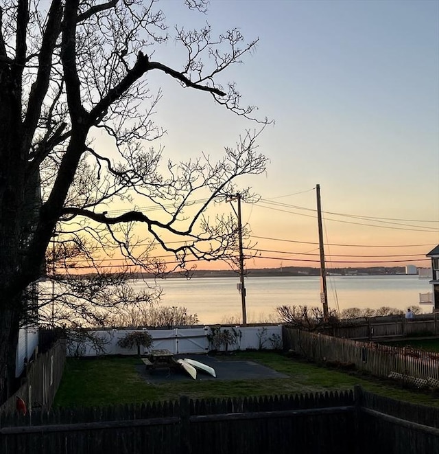 property view of water with a fenced backyard