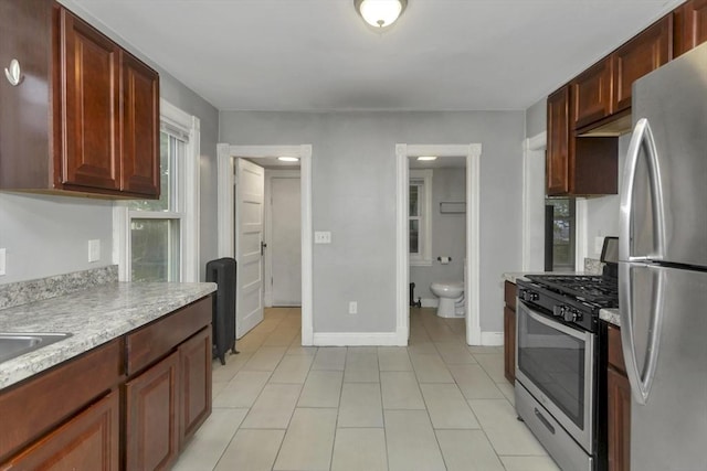 80 Rochelle St, Springfield, MA 01109 - kitchen with appliances with stainless steel finishes, light countertops, light tile patterned floors, and baseboards