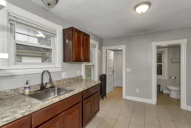 80 Rochelle St, Springfield, MA 01109 - kitchen featuring a sink, light tile patterned floors, light countertops, and baseboards