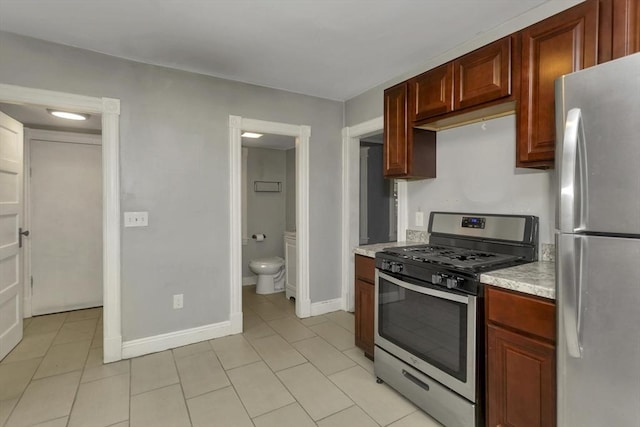 80 Rochelle St, Springfield, MA 01109 - kitchen with appliances with stainless steel finishes, light tile patterned floors, baseboards, and light stone counters