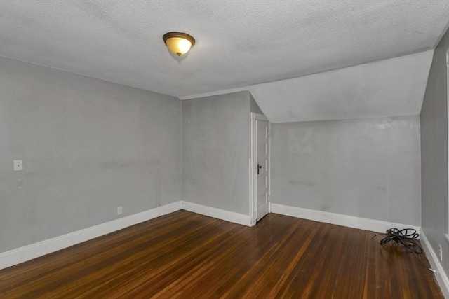 80 Rochelle St, Springfield, MA 01109 - additional living space with wood-type flooring, lofted ceiling, baseboards, and a textured ceiling