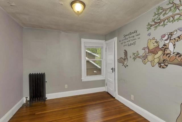 80 Rochelle St, Springfield, MA 01109 - empty room featuring radiator heating unit, hardwood / wood-style flooring, a textured ceiling, and baseboards