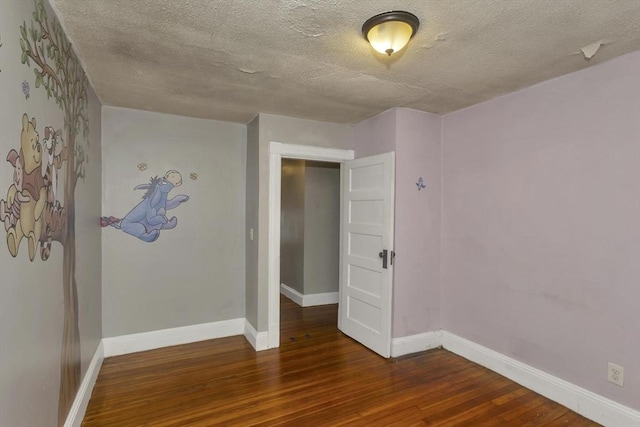 80 Rochelle St, Springfield, MA 01109 - empty room with wood finished floors, baseboards, and a textured ceiling
