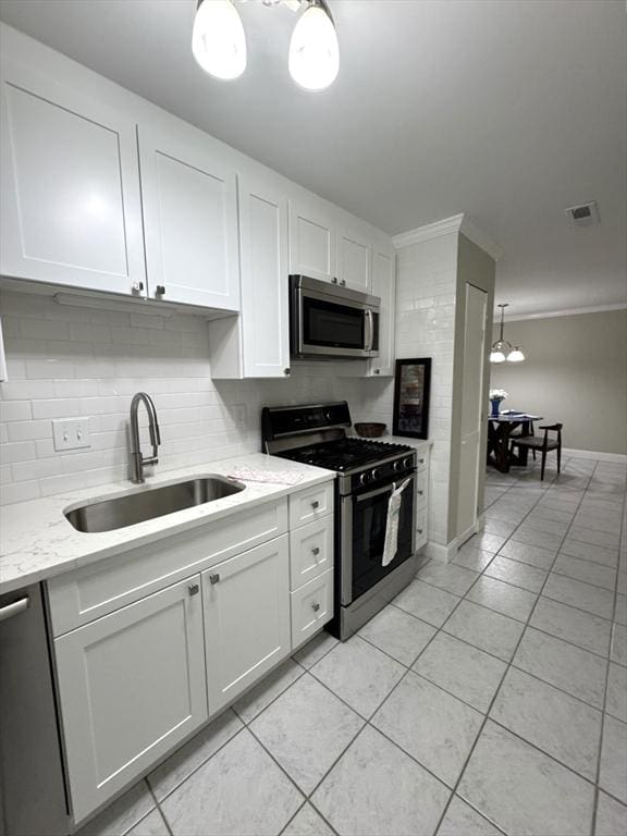 kitchen with white cabinetry, visible vents, stainless steel appliances, and a sink